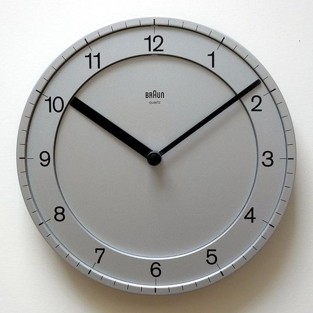 A clock with the hands moving slowly.