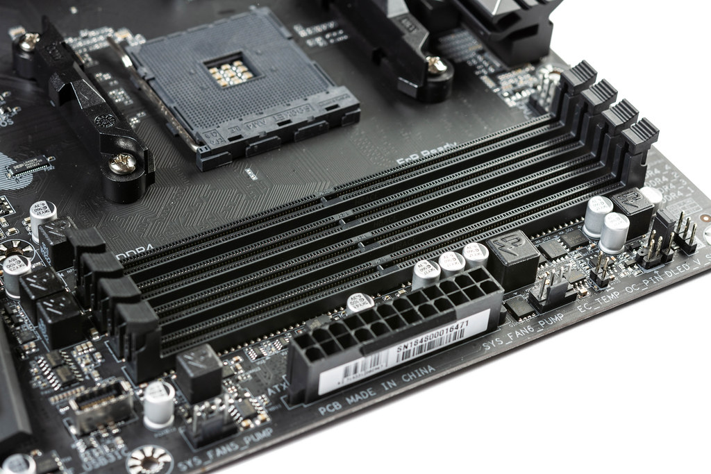 A computer motherboard with visible RAM slots.