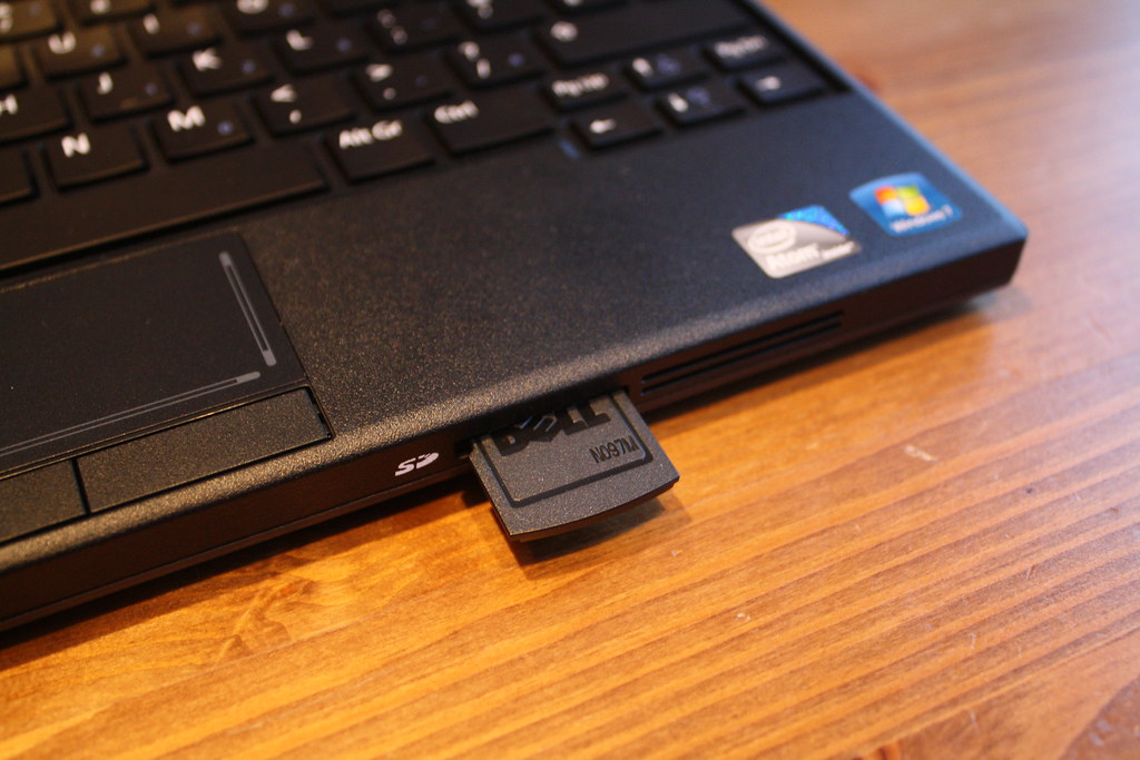 Image of a computer with an SD card being inserted into a slot